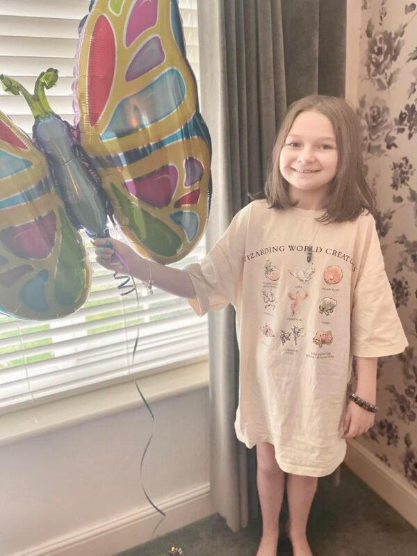 Isla holding butterfly balloon