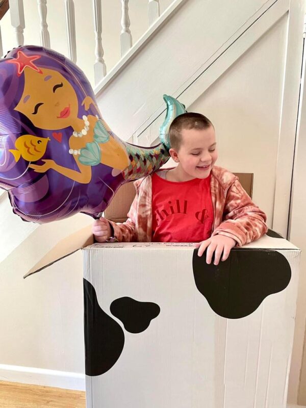 Tayen in box with mermaid balloon